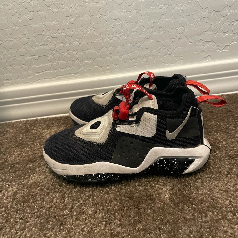 Kids black Nike shoes